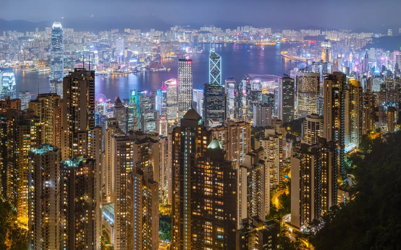 Hong Kong’s towers and Victoria Harbour lit up at night, from the Peak