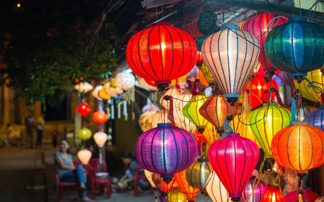 Silk lanterns glowing in a Hội An street at night